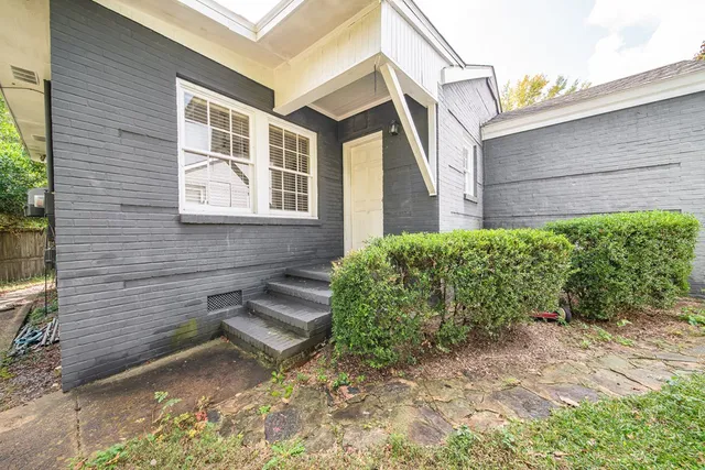 a view of a backyard with sitting area