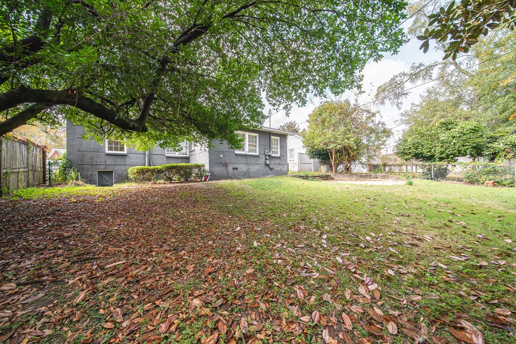 1705 Slade Drive Columbus, GA 31901 - Photo 35 of 37 a brick house with a big yard and large trees