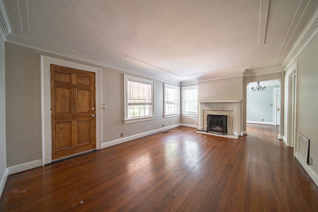 1705 Slade Drive Columbus, GA 31901 - Photo 6 of 37 an empty room with wooden floor fireplace and windows