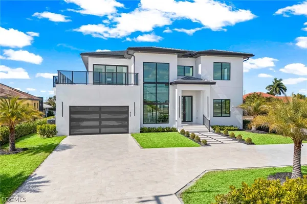 a front view of a house with a yard table and chairs