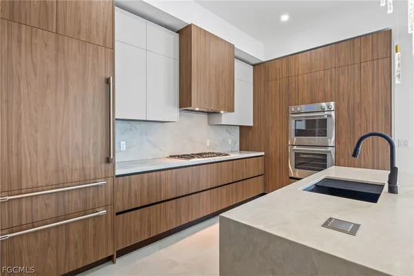 a kitchen with a sink cabinets and a window
