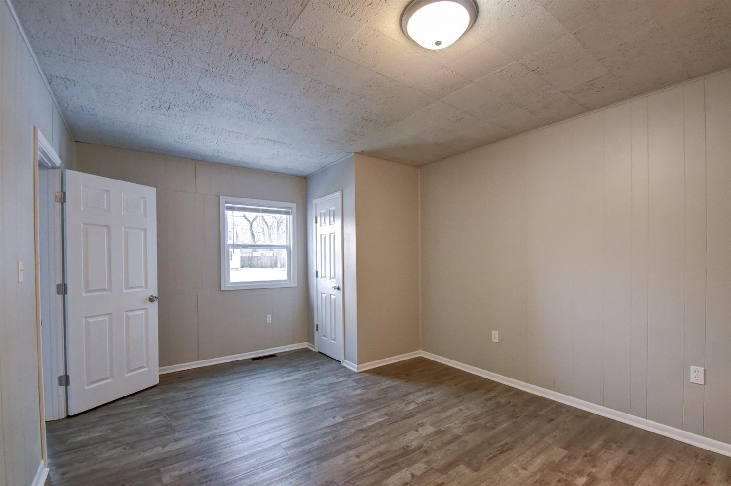 2100 Ranburn Drive Gary, IN 46408 - Photo 13 of 23 an empty room with wooden floor and windows
