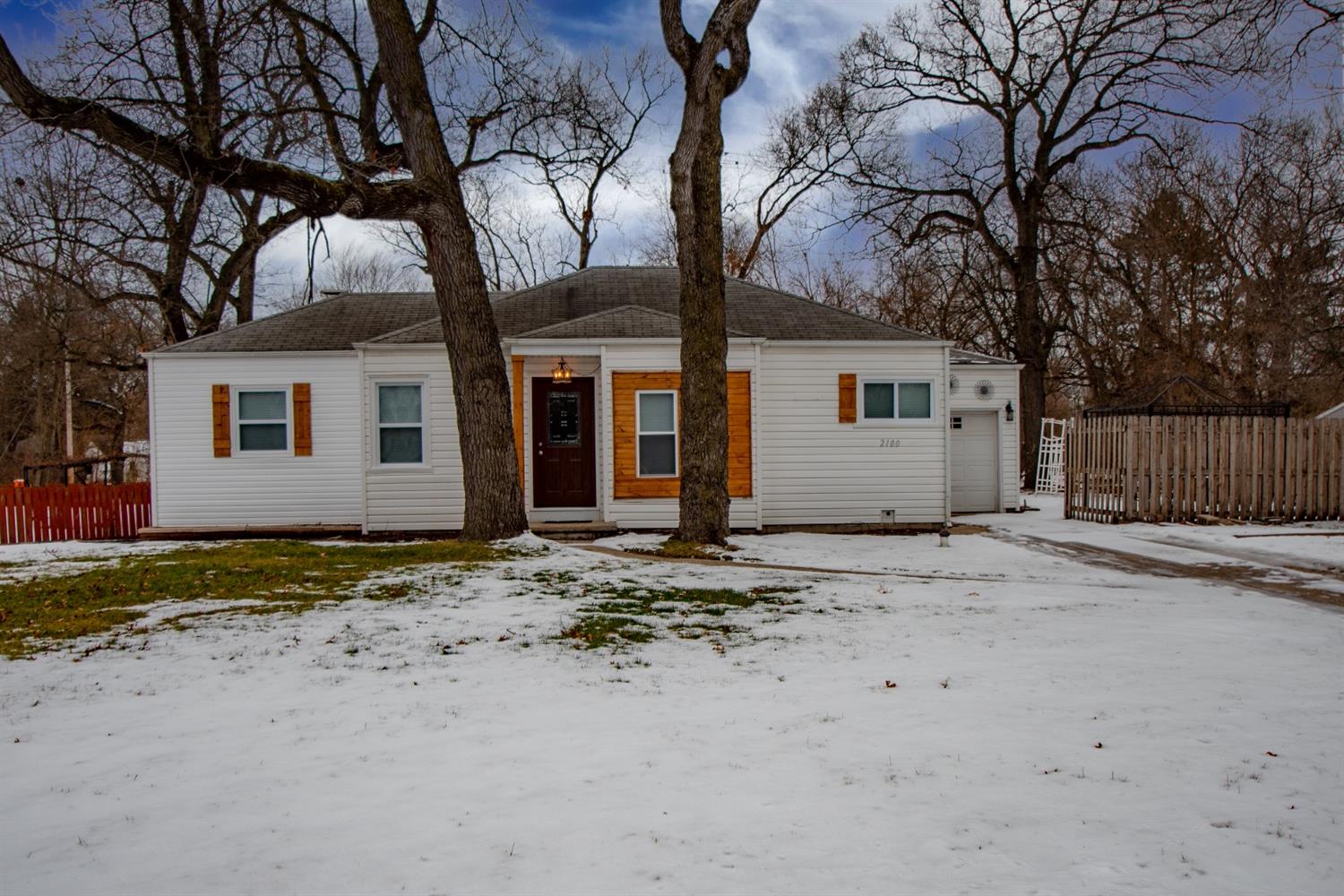 2100 Ranburn Drive Gary, IN 46408 - Photo 3 of 23 a backyard of a house with wooden fence and large tree