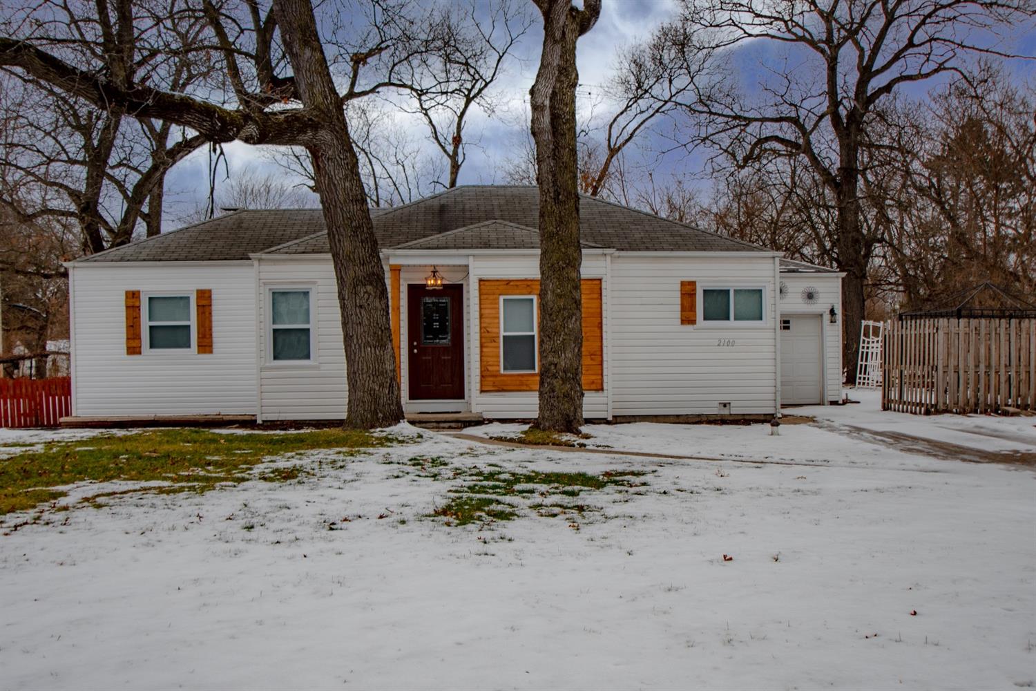 2100 Ranburn Drive Gary, IN 46408 - Photo 4 of 23 a front view of a house with a dirt yard and a large tree