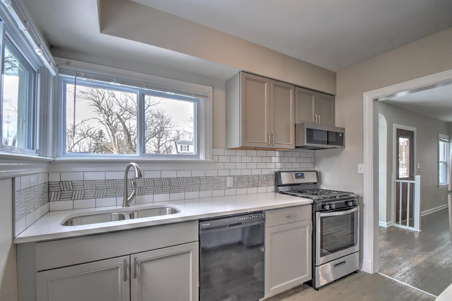 2100 Ranburn Drive Gary, IN 46408 - Photo 6 of 23 a kitchen with appliances a sink and cabinets