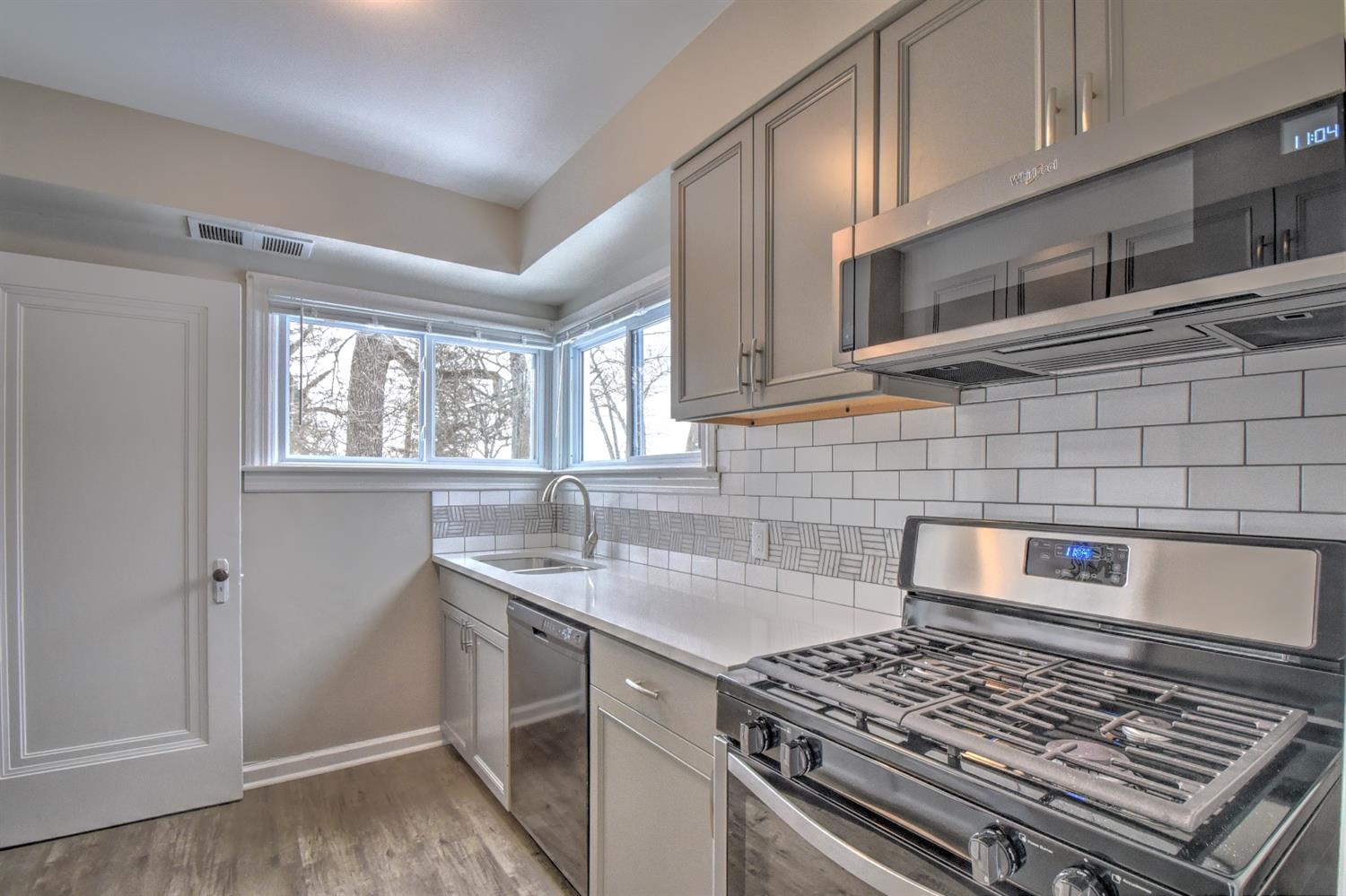 2100 Ranburn Drive Gary, IN 46408 - Photo 7 of 23 a kitchen with cabinets and a stove top oven
