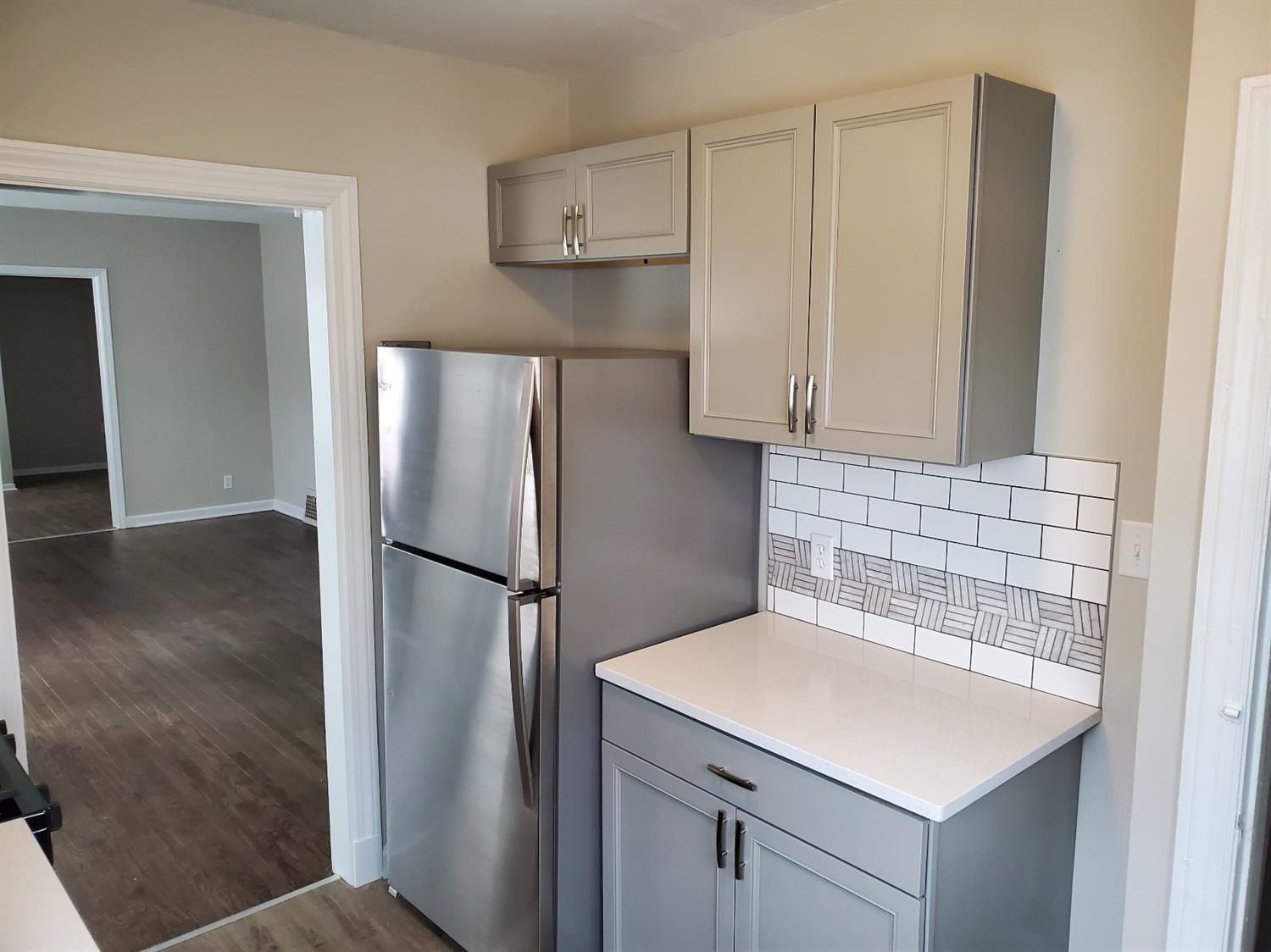 2100 Ranburn Drive Gary, IN 46408 - Photo 8 of 23 a kitchen with a sink a refrigerator and cabinets