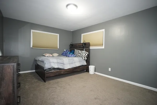 a bedroom with a bed and wall painting