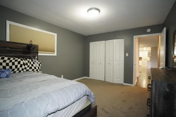 a bedroom with a bed and a dresser