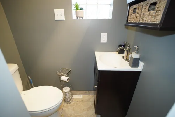 a bathroom with a sink a toilet and mirror