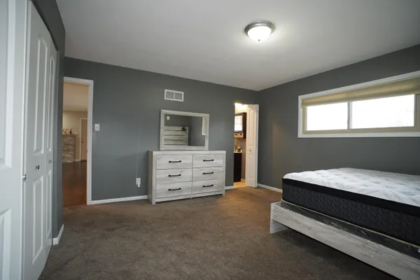 a room with a bed and furniture