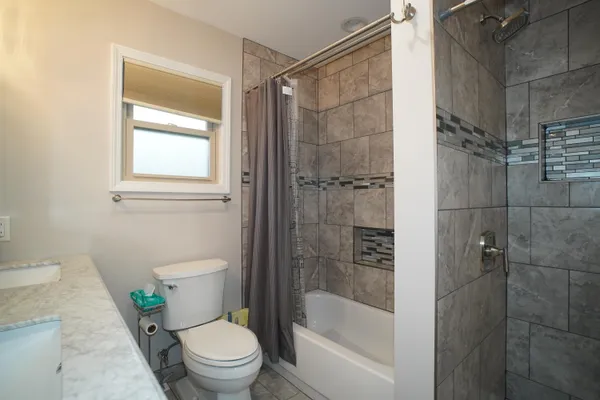 a bathroom with a shower a toilet and a shower