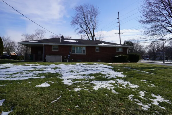 a front view of house with yard and trees