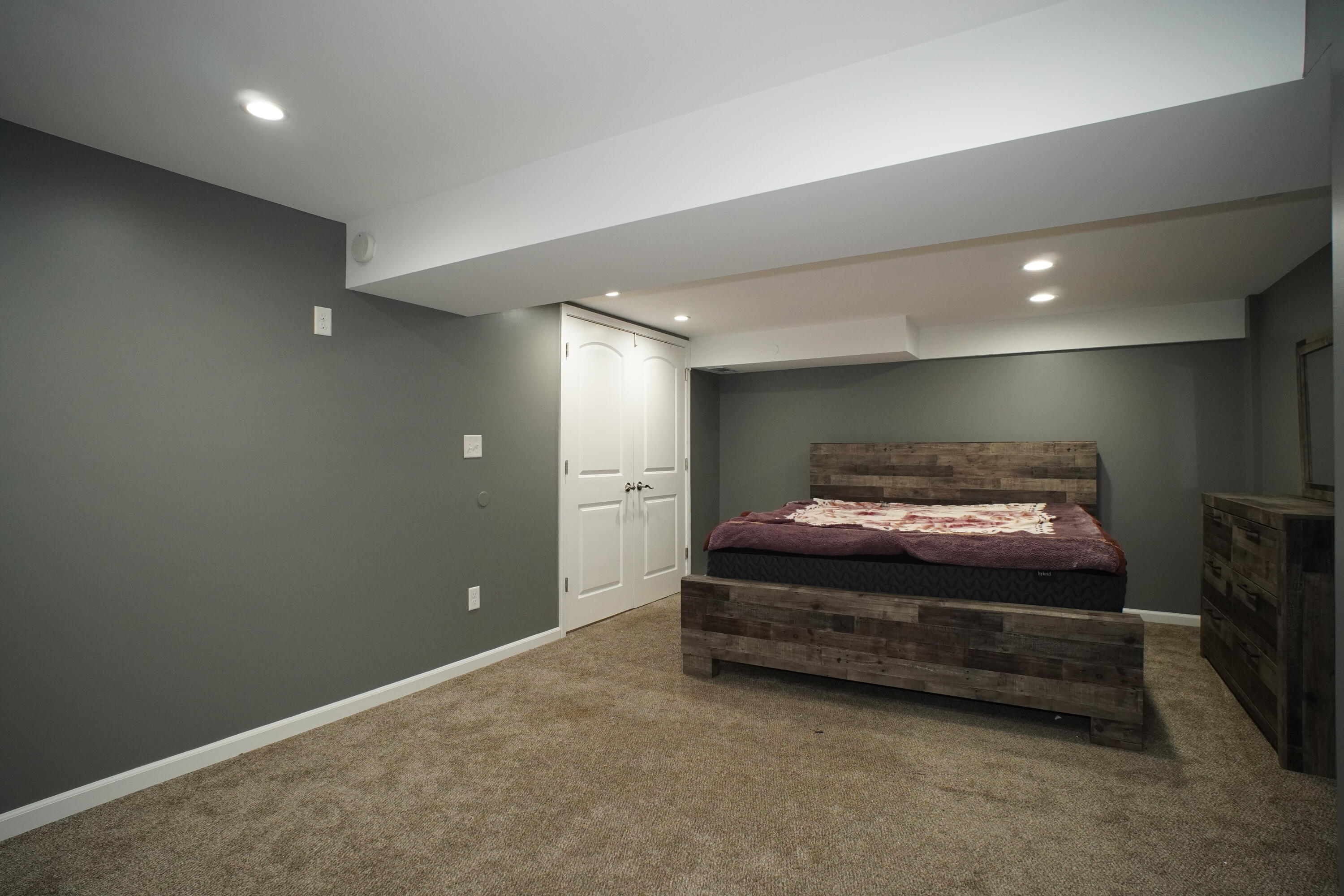 6092 Cleveland Street Merrillville, IN 46410 - Photo 26 of 32 a spacious bedroom with a bed and a night stand