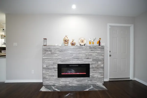 a living room with a fireplace and a wooden floor