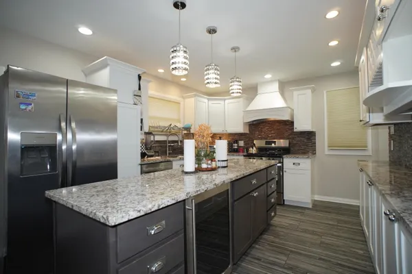 a kitchen with kitchen island granite countertop a center island and stainless steel appliances