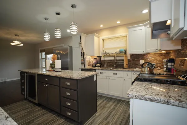 a kitchen with a sink stove and cabinets
