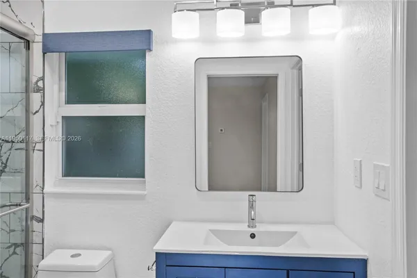a bathroom with a toilet sink and mirror