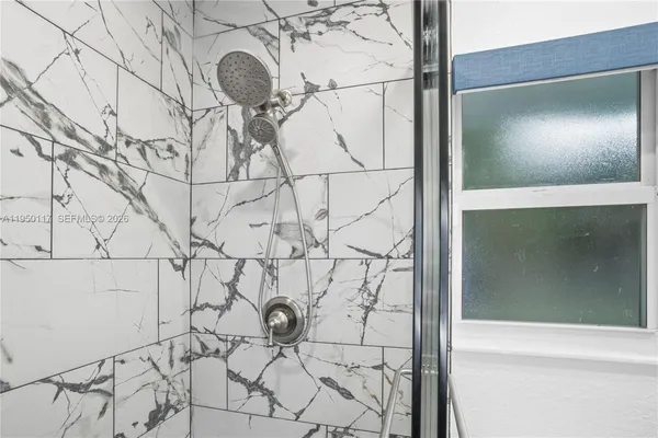 a bathroom with a shower and a mirror