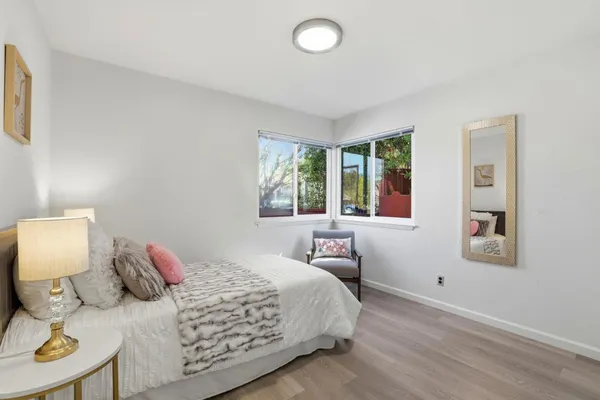 a bedroom with a bed and wooden floor