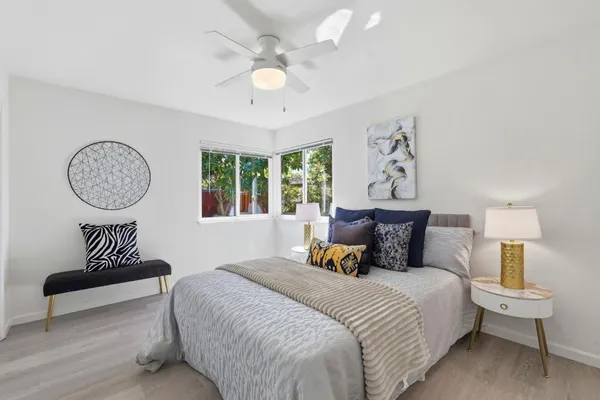 a bedroom with a bed and a lamp on table