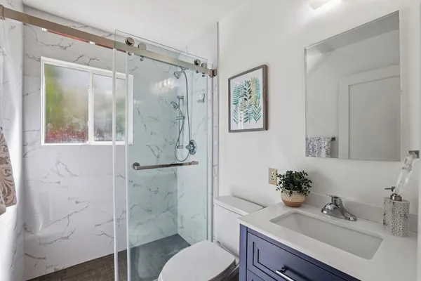 a bathroom with a sink toilet and shower