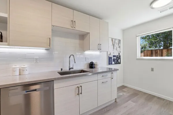a kitchen with a sink cabinets and window