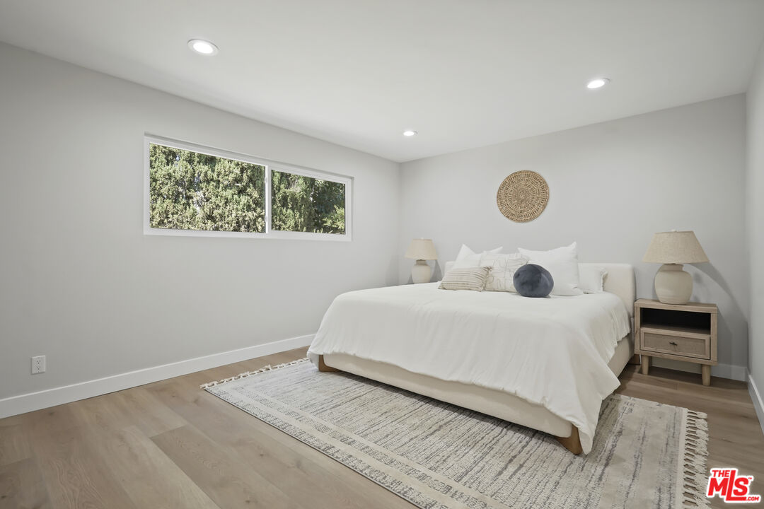19009 Celtic Street Porter Ranch, CA 91326 - Photo 14 of 28 a bedroom with a bed and a large window