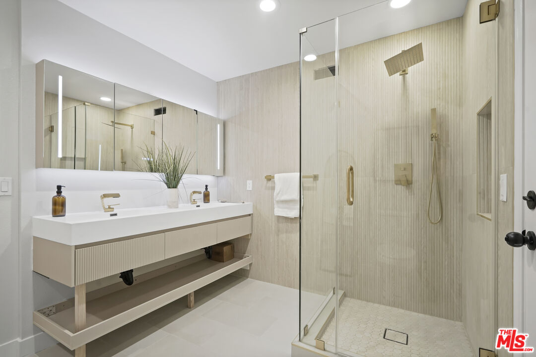 19009 Celtic Street Porter Ranch, CA 91326 - Photo 16 of 28 a bathroom with a double vanity sink mirror and shower