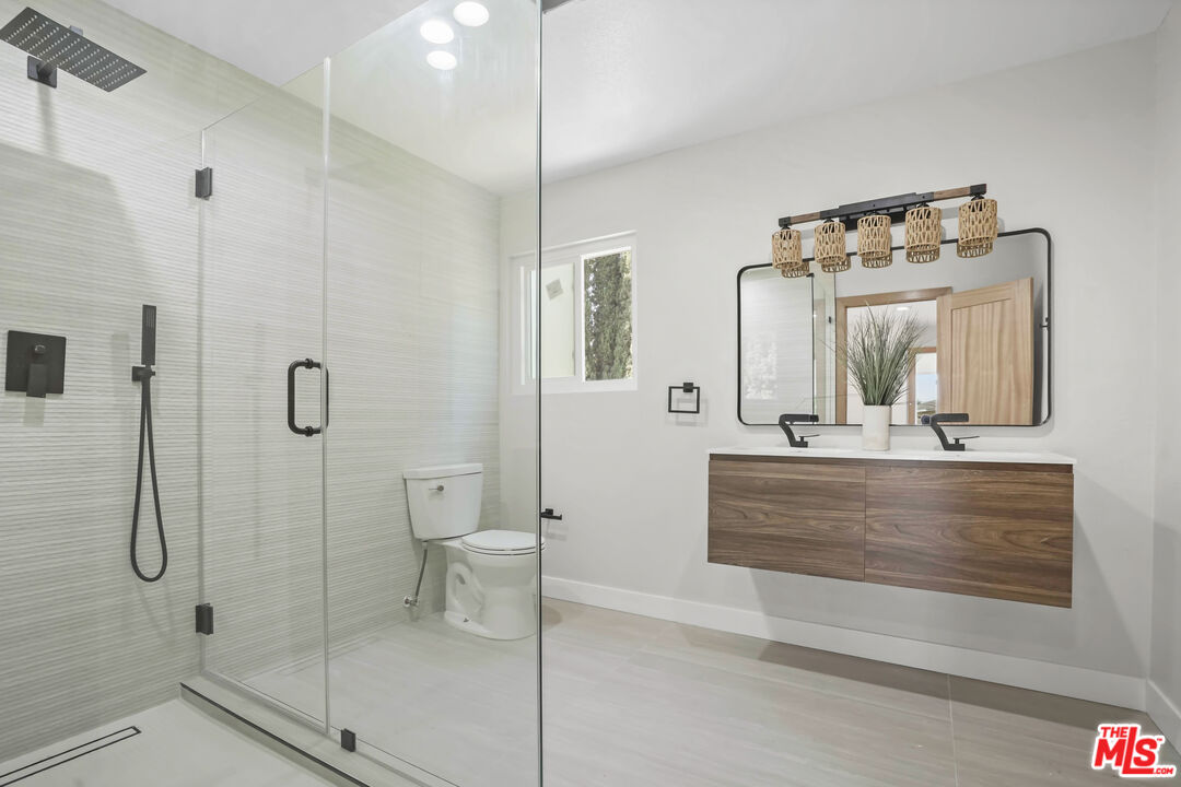 19009 Celtic Street Porter Ranch, CA 91326 - Photo 20 of 28 a bathroom with a double vanity sink mirror and shower