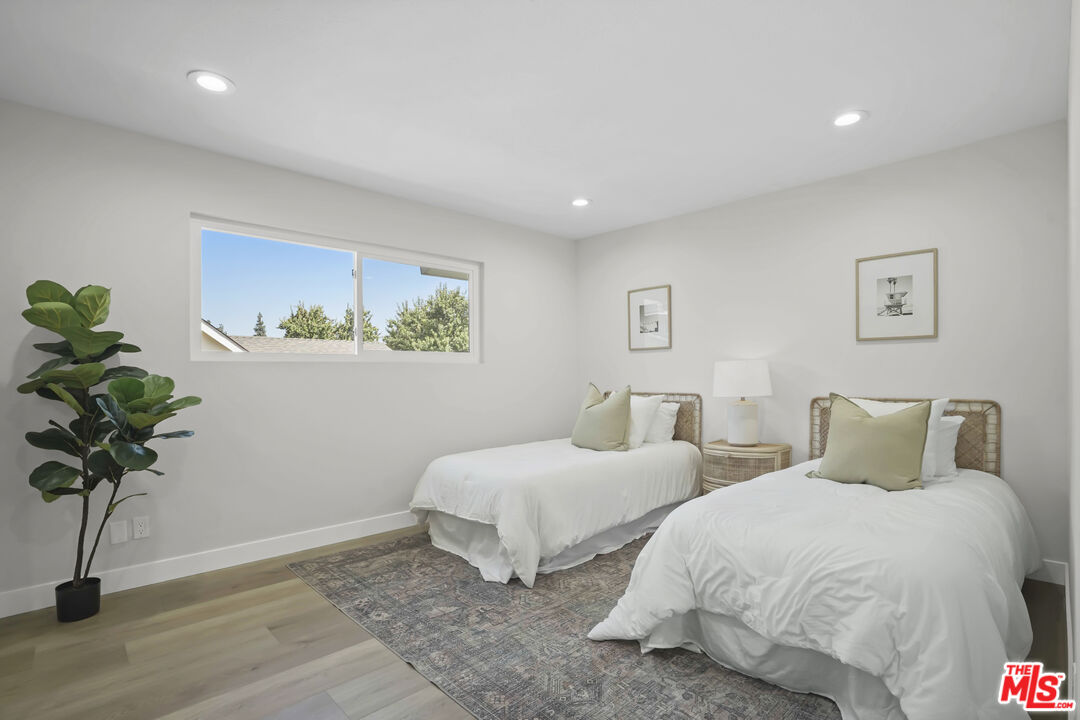 19009 Celtic Street Porter Ranch, CA 91326 - Photo 21 of 28 a bedroom with two beds and a potted plant