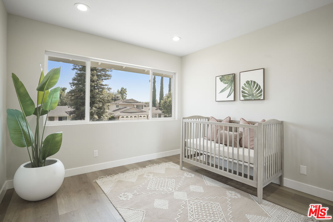 19009 Celtic Street Porter Ranch, CA 91326 - Photo 23 of 28 a view of a bedroom with furniture and a potted plant