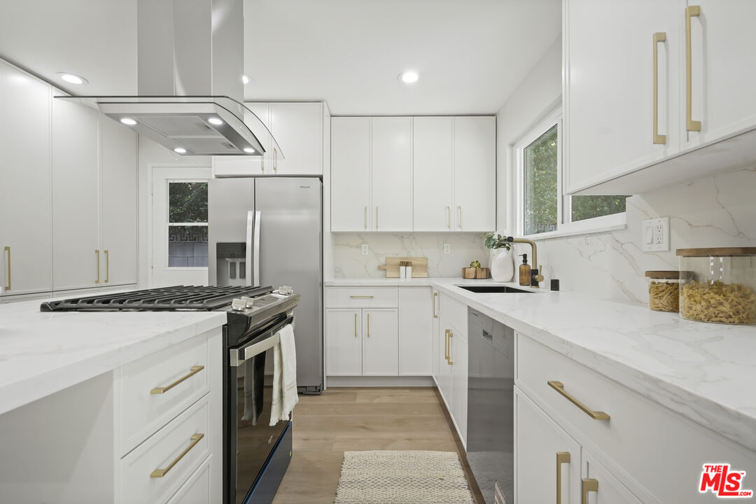 19009 Celtic Street Porter Ranch, CA 91326 - Photo 9 of 28 a kitchen with a stove sink and refrigerator
