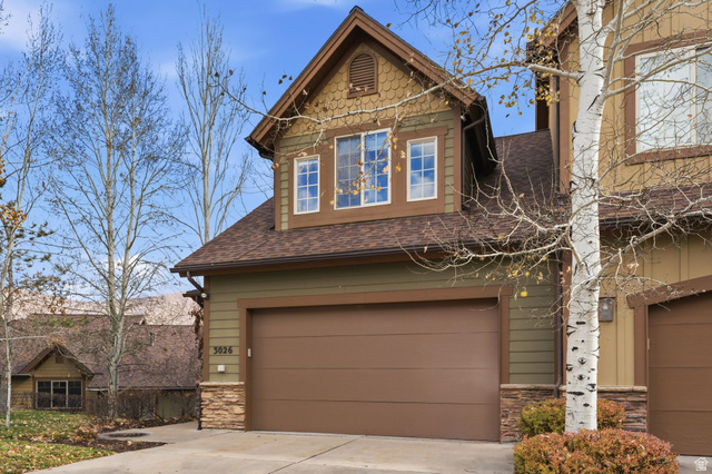3026 Lower Saddleback Road Park City, UT 84098 - Photo 65 of 71 View of front of house featuring stone siding, roof with shingles, an attached garage, and driveway