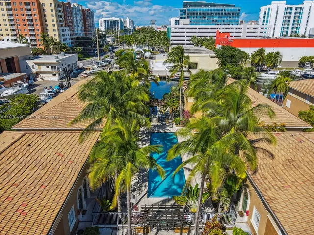 an aerial view of a house with a yard and potted plants