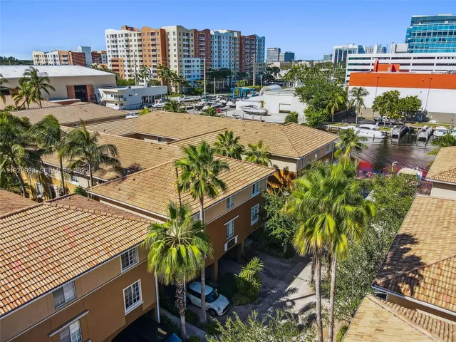 an aerial view of multiple houses with yard