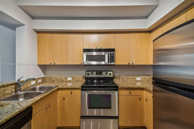 a kitchen with a refrigerator and cabinets