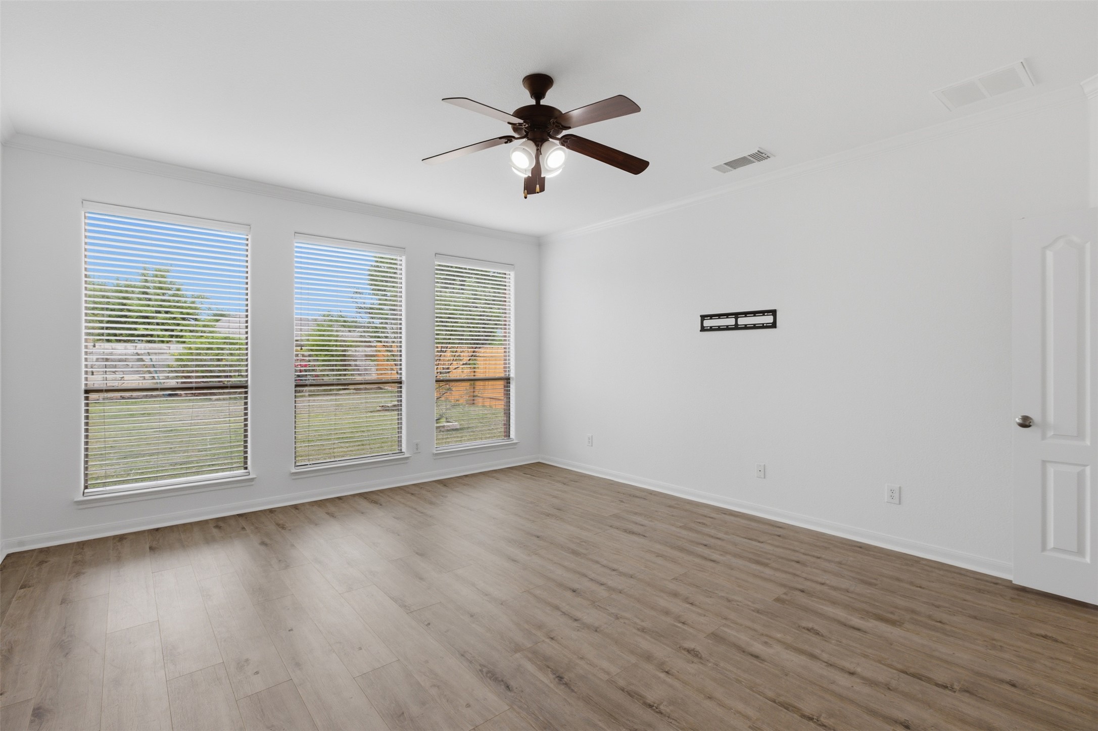 2909 Agave Loop Round Rock, TX 78681 - Photo 16 of 38 Master room featuring ceiling fan, ornamental molding, and light wood-style flooring