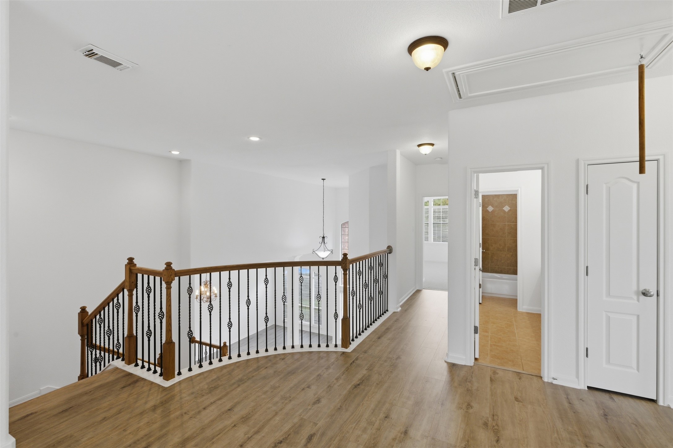 2909 Agave Loop Round Rock, TX 78681 - Photo 20 of 38 Corridor with an upstairs landing, light wood-style flooring, and recessed lighting