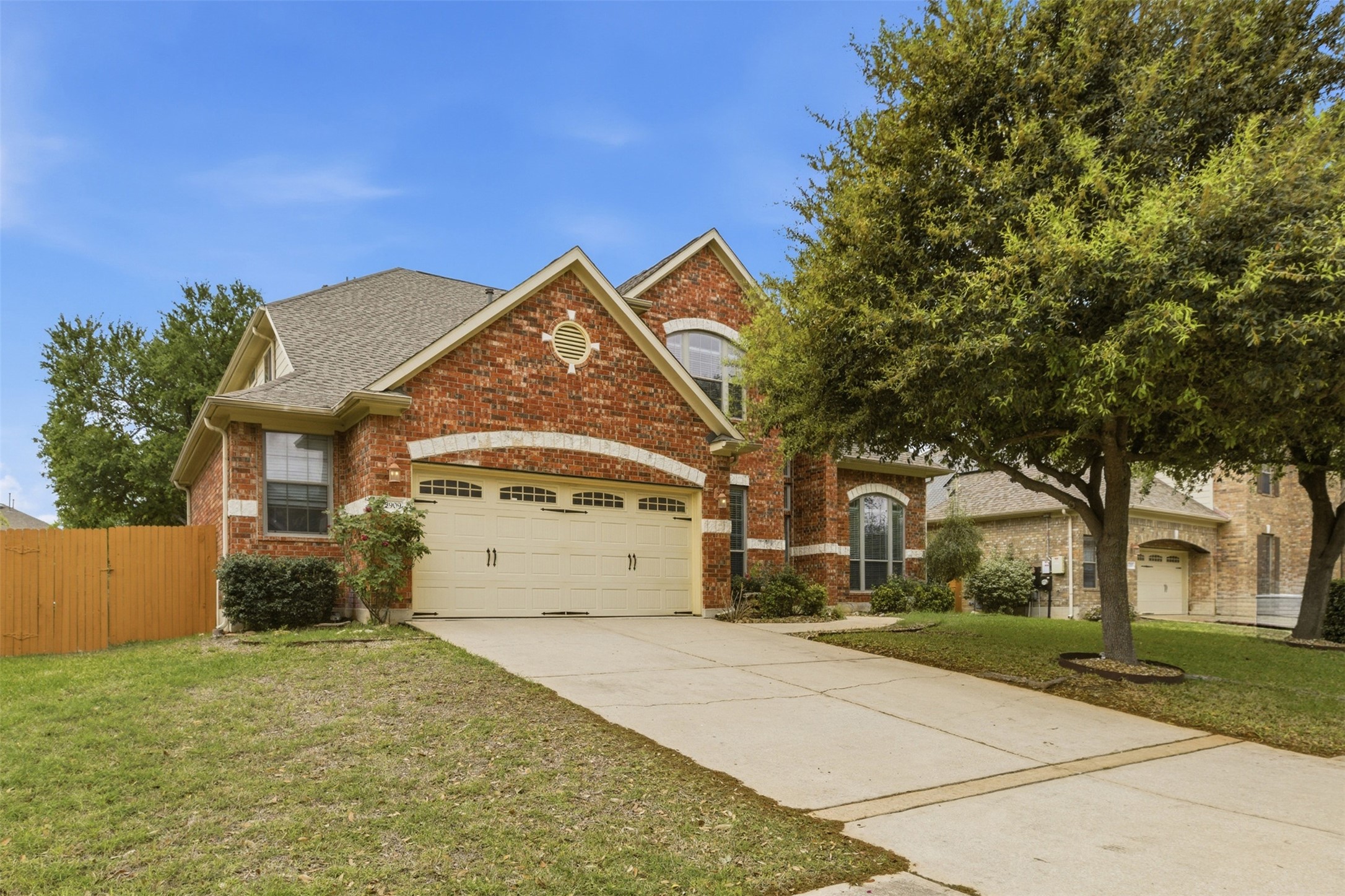 2909 Agave Loop Round Rock, TX 78681 - Photo 2 of 38 View of front of house with an attached 2.5 garage, driveway, brick siding, and a gate