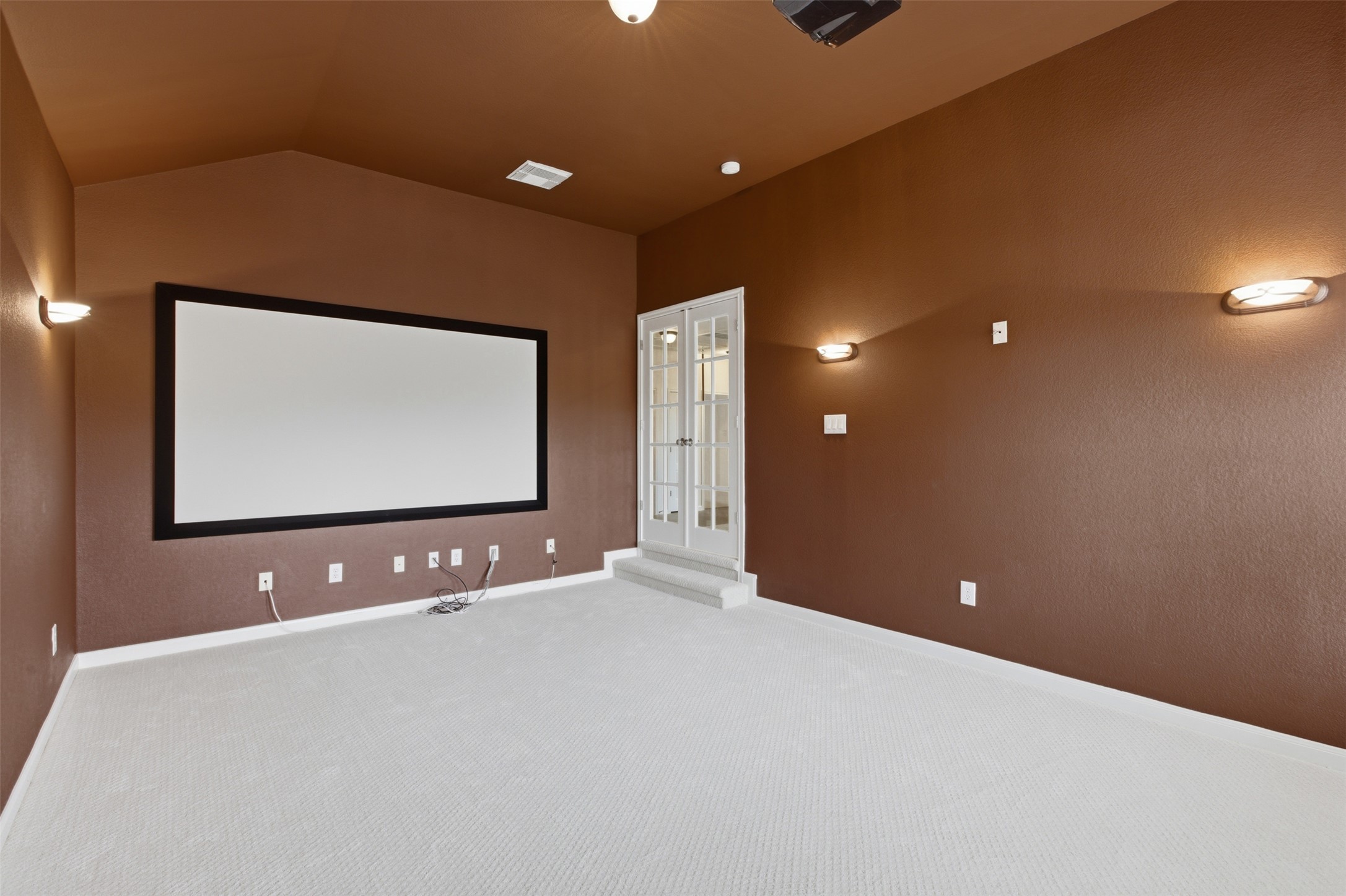 2909 Agave Loop Round Rock, TX 78681 - Photo 22 of 38 Carpeted home theater with lofted ceiling and french doors