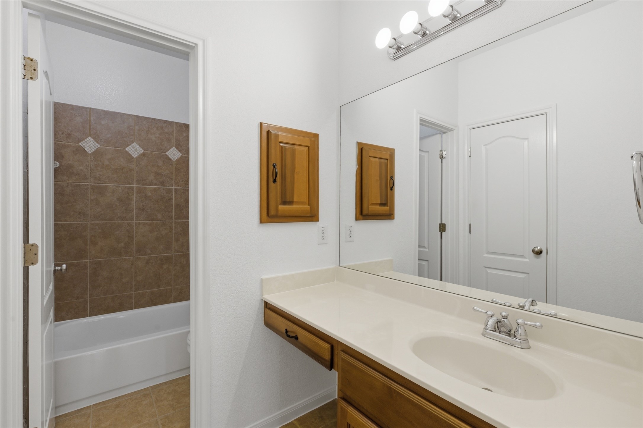 2909 Agave Loop Round Rock, TX 78681 - Photo 24 of 38 Full bath 4 with vanity, light tile patterned floors, and bathing tub / shower combination