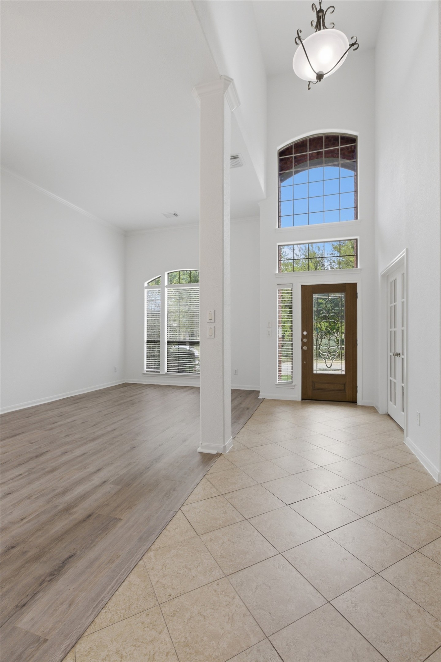 2909 Agave Loop Round Rock, TX 78681 - Photo 4 of 38 Foyer entrance showing Living Room with light tile patterned flooring and a high ceiling