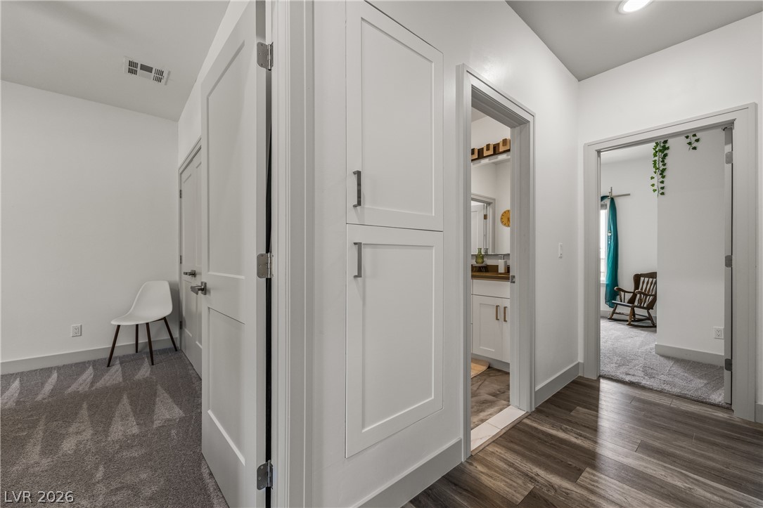 3020 Hannig Street Logandale, NV 89021 - Photo 37 of 75 Clean lines and modern cabinetry define this versatile interior space, connecting rooms with both carpet and wood flooring.