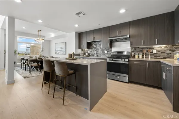 a kitchen with stainless steel appliances a stove sink and cabinets
