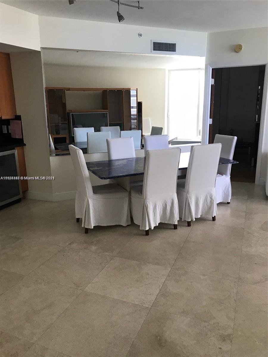 9595 Collins Avenue, Unit N9I Surfside, FL 33154 - Photo 3 of 6 a living room with furniture and a flat screen tv