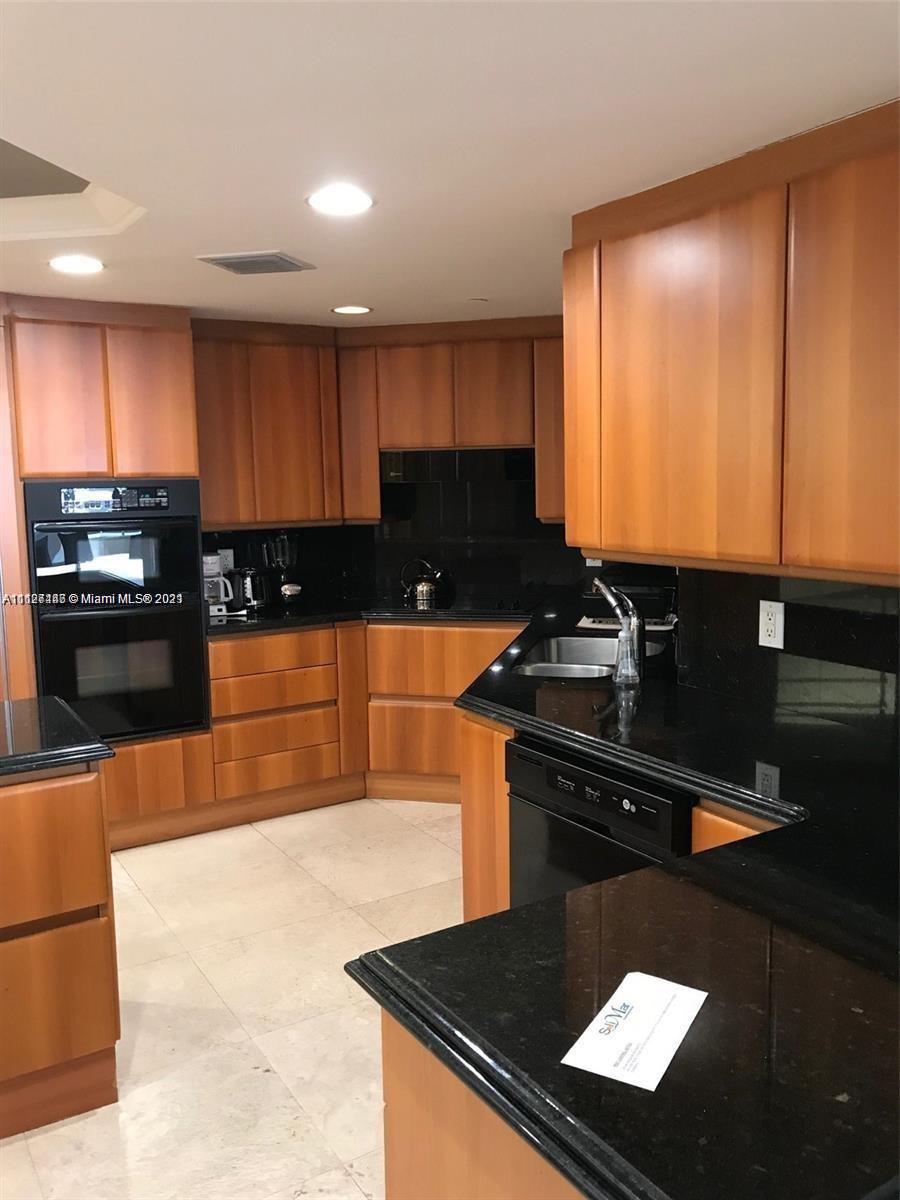9595 Collins Avenue, Unit N9I Surfside, FL 33154 - Photo 6 of 6 a kitchen with a sink a stove and cabinets