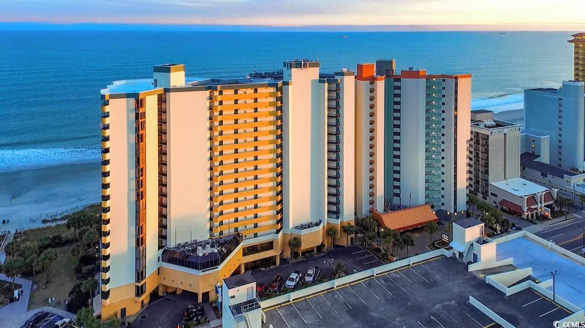 2710 North Ocean Boulevard, Unit 402 Myrtle Beach, SC 29577 - Photo 30 of 32 Aerial view at dusk of a view of apartment building / complex and a water view
