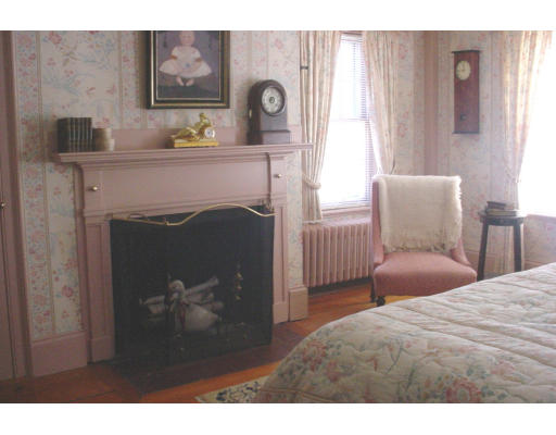 80 First Parish Road Scituate, MA 02066 - Photo 2 of 14 a bedroom with a bed and a fireplace