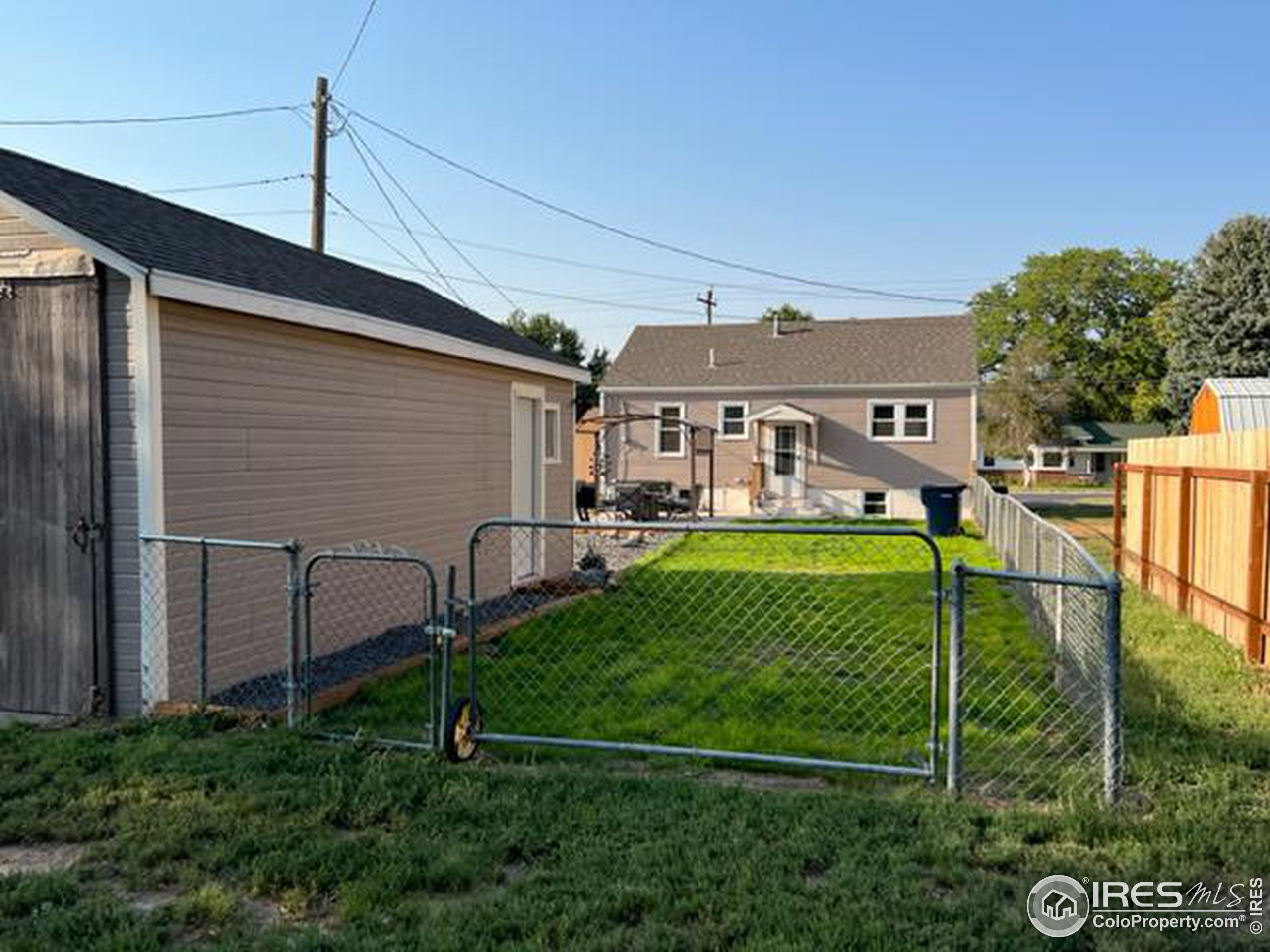1124 West 7th Street Wray, CO 80758 - Photo 3 of 11 a view of a white house in front of a yard